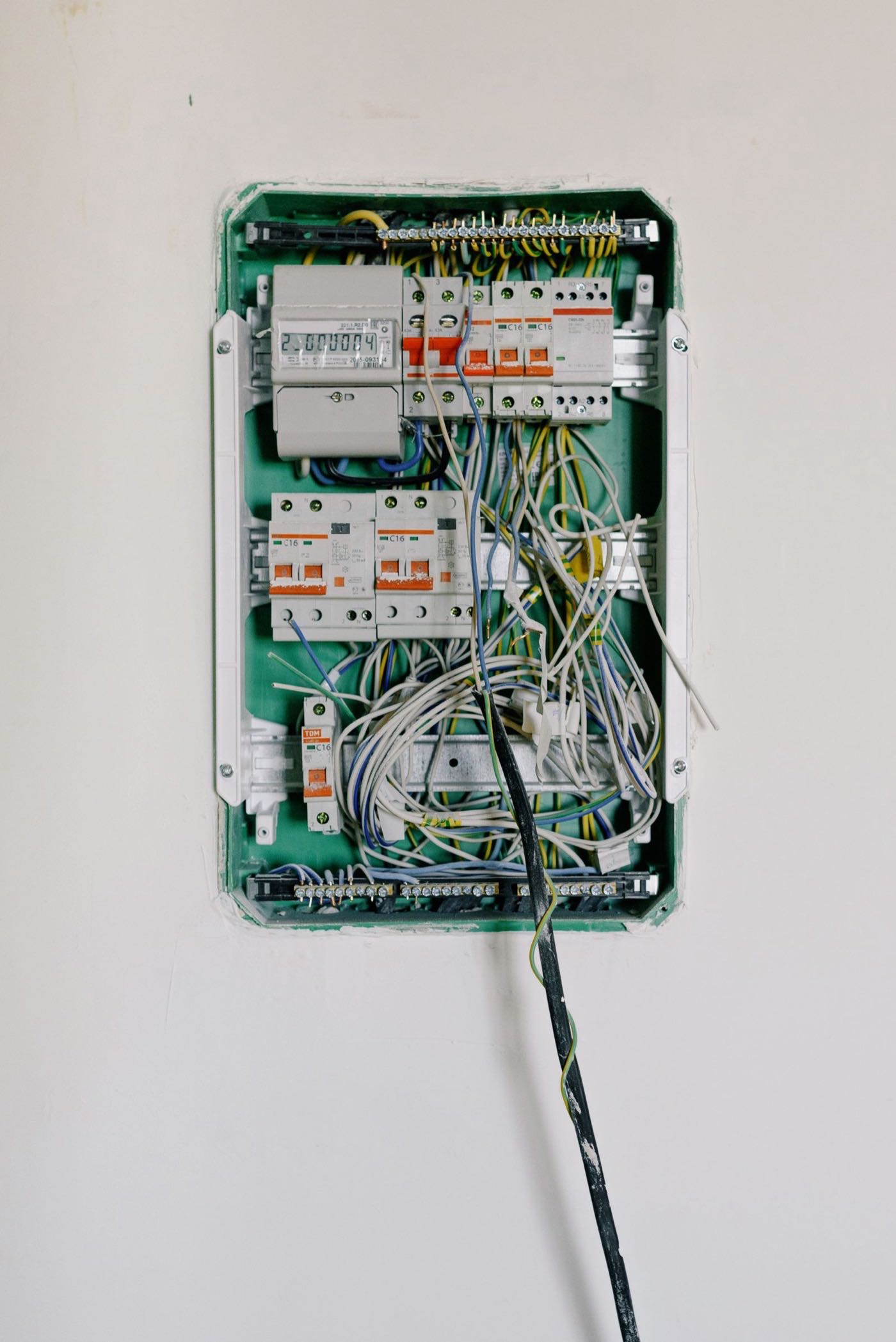 New breaker panel mounted on a wall after a residential panel replacement