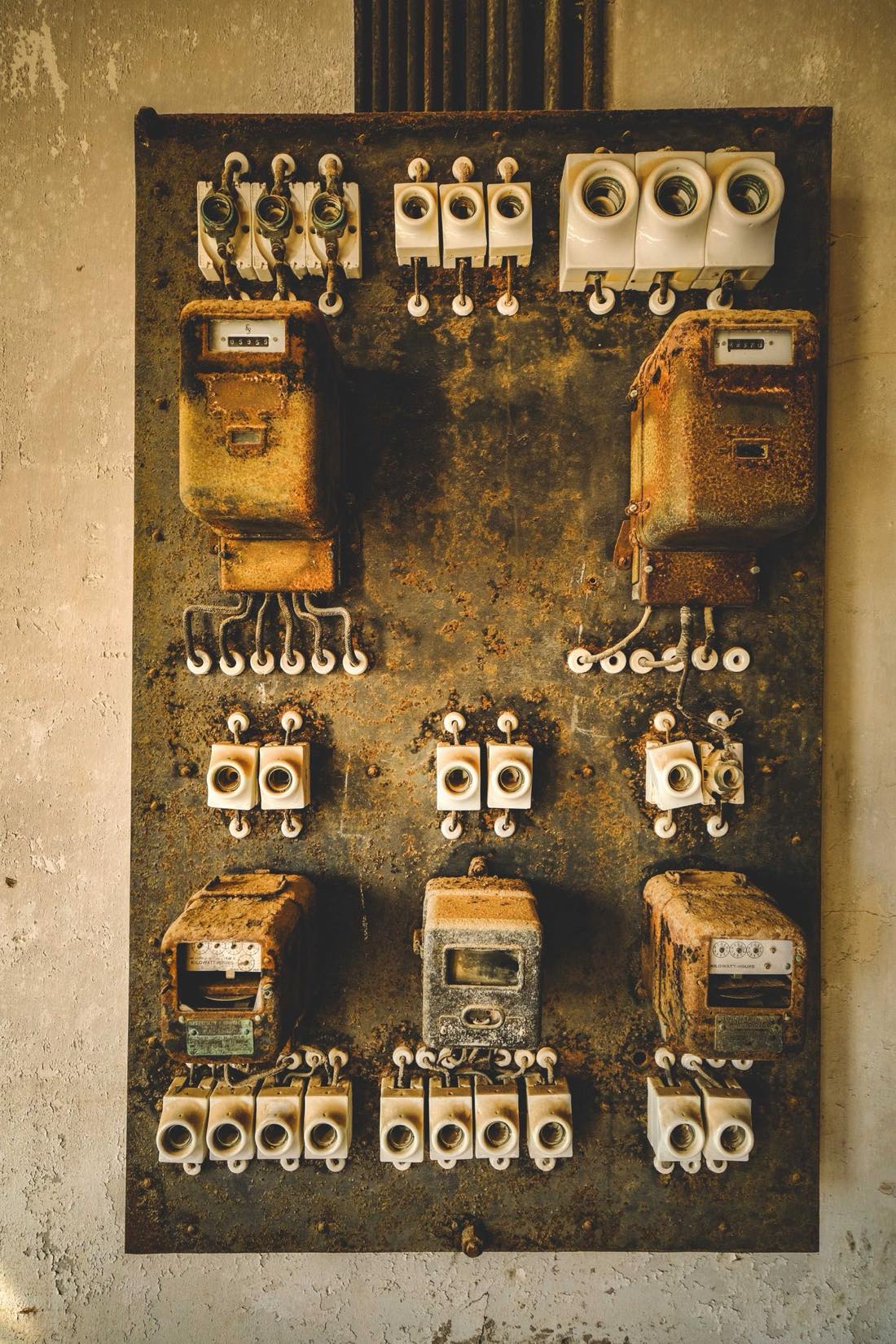 Vintage residential electrical panel from the Commander and Sylvania era, with the door open showing aged fuses and wiring
