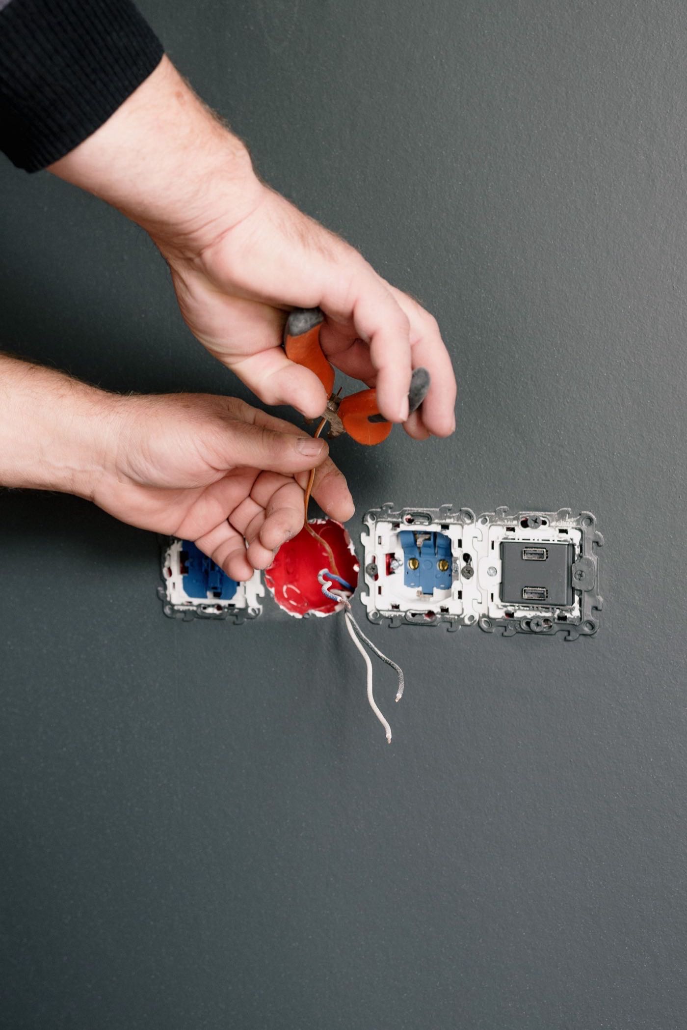 Electrician installing sockets and switches during residential electrical work
