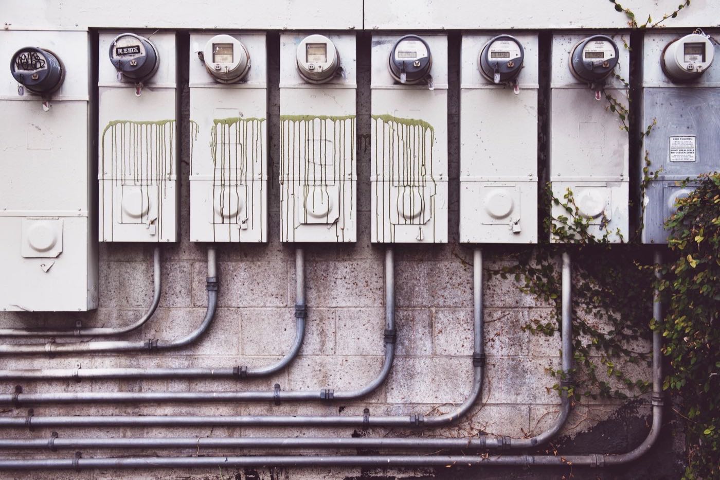 Electrical meters mounted on the brick wall of a residential building