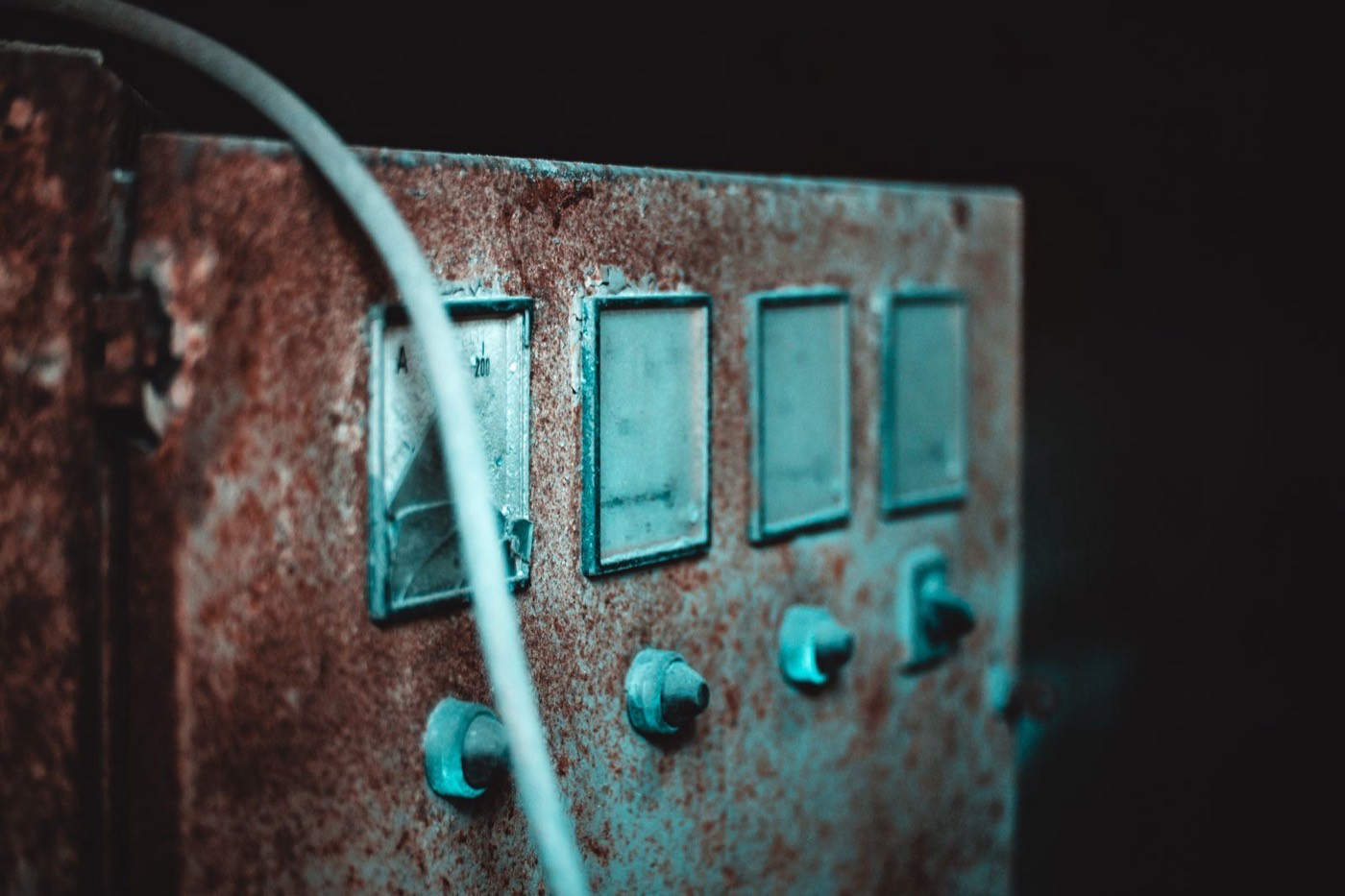 Rusty vintage electrical panel with old dials, typical of the original equipment still found in century homes